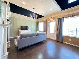 a living room with a couch and a tv at Haven at Hazel Downtown Loft in Demorest