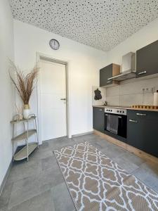 a kitchen with a clock on the ceiling at Apartment Leitha Living Cozy in Götzendorf an der Leitha