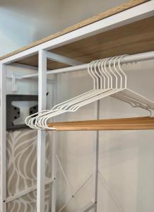 a closet with wood and white shelving at Apartment Leitha Living Cozy in Götzendorf an der Leitha +12 photos