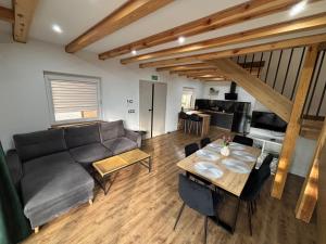 a living room with a couch and a table at Samson Park Noclegi in Stacja Dlugi Kat +6 photos