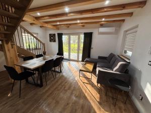 a living room with a couch and a table and chairs at Samson Park Noclegi in Stacja Dlugi Kat