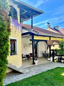 a house with a patio with chairs and tables at Apartments Dajčić in Varaždinske Toplice