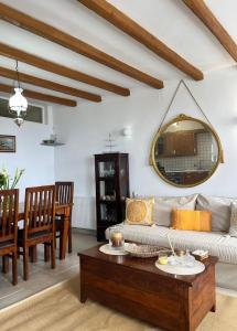 a living room with a couch and a table at Aegean Breeze in DYO CHORIA TINOS in Triandáros