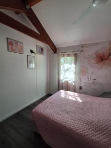 a bedroom with a bed and a window at les petits chassezac in Grospierres