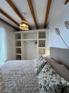 a bedroom with a large bed and a ceiling at Aegean Breeze in DYO CHORIA TINOS in Triandáros