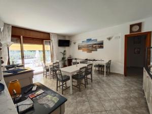 a kitchen and dining room with a table and chairs at Casa Glicine in Finale Ligure