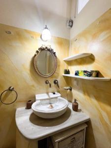 a bathroom with a sink and a mirror at Aegean Breeze in DYO CHORIA TINOS in Triandáros +39 photos