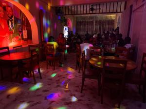 a group of people sitting at tables in a restaurant at La Belle Maison Milot in Samson
