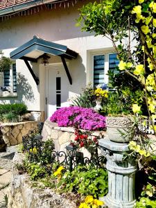 a flower garden in front of a house at Apartments Dajčić in Varaždinske Toplice