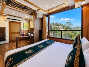 a bedroom with a bed with a large window at Anandam Near Mall Road in Shimla +56 photos