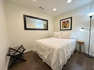 a bedroom with a bed and a mirror on the wall at Haven at Hazel Downtown Loft in Demorest +13 photos