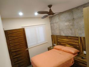a bedroom with a bed and a ceiling fan at Condo arrosito village in Tangolunda +6 photos