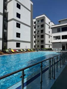 a swimming pool in front of two buildings at Nessie Homes in Nairobi