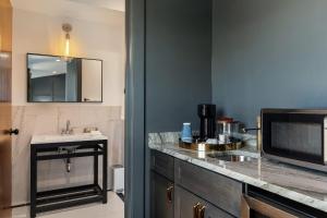 a bathroom with a sink and a counter with a sink at Superior King Room at The Emerald in Beaufort +7 photos