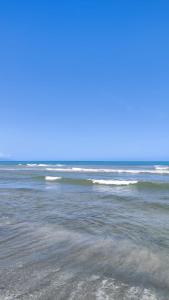 an empty beach with the ocean in the background at Camping watiwara in Buritaca