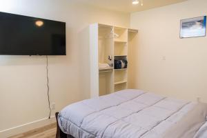 a bedroom with a bed and a flat screen tv at Duchesne River LLC in Duchesne