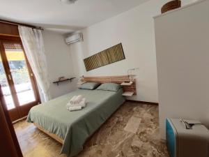 a bedroom with a bed with a towel on it at Casa Glicine in Finale Ligure