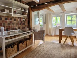 a kitchen with a table and chairs in a room at Ferienhaus Landhaus Am Hirtzborn in Marburg an der Lahn