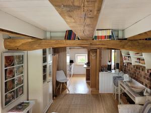 a kitchen and living room with wooden beams at Ferienhaus Landhaus Am Hirtzborn in Marburg an der Lahn