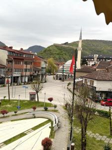 a view of a town with a street and a church at Spring Studio Apartment in Prizren
