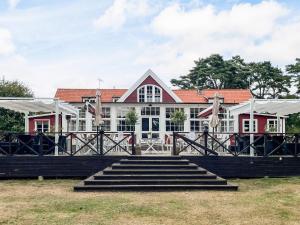 a large red and white building with stairs in front at 4 star holiday home in SÖLVESBORG in Sölvesborg
