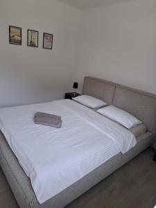 a large white bed with two pillows on it at B&B Marysol in Arcegno
