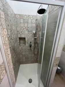 a shower with a glass door in a bathroom at L'altra opera in Palermo +18 photos