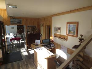 a room with a staircase and a desk with a computer at Les Chambres du Phoebus in La Tremblade