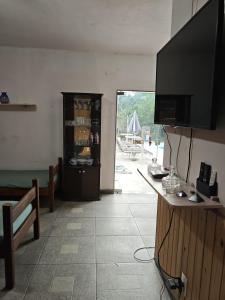 a living room with a flat screen tv on the wall at Casa da mãe joanna in Guapimirim