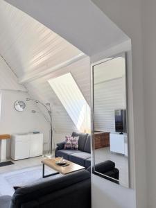 a living room with a couch and a mirror at KM APPARTS Wesel 6 in Wesel
