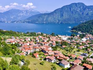 a small town on a hill next to a body of water at Il nido di Lera in Lenno
