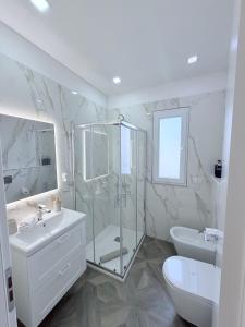 a bathroom with a shower and a sink and a toilet at Maison24 in Martinsicuro +25 photos