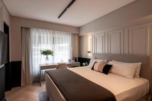a bedroom with a bed and a desk and a window at CasaSur Recoleta in Buenos Aires +33 photos