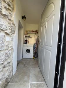 a laundry room with a washer and dryer next to a door at Papiria Residence in Piovene Rocchette