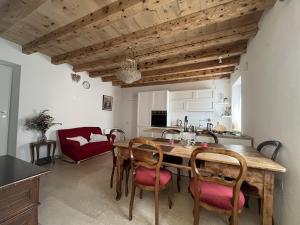 a kitchen and dining room with a wooden table and chairs at Papiria Residence in Piovene Rocchette
