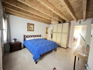 a large bedroom with a large bed with a blue comforter at Papiria Residence in Piovene Rocchette