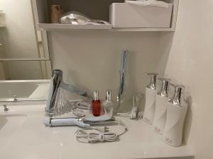a bathroom counter with a sink with some appliances on it at ReFa room由来House in Kumamoto