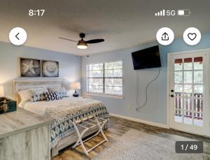 a bedroom with a bed and a flat screen tv at Pet Friendly | Pool | Tennis | Walk to Shops in Hilton Head Island