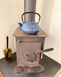 a pot on top of a stove with a bowl on it at Shepherd's Hut near Oxford in Cumnor