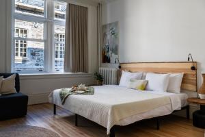 ein Schlafzimmer mit einem großen Bett und weißen Kissen in der Unterkunft Lofts Le Petit Champlain in Québec