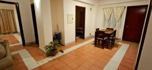 a living room with a desk and a table in a room at Shillong Serviced Apartment in Shillong