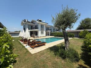 a villa with a swimming pool and a house at Villa Atay in Dalyan