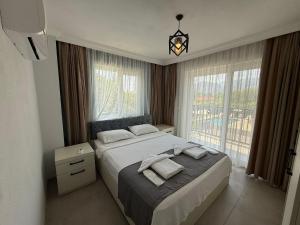 a bedroom with a bed and a large window at Villa Atay in Dalyan +15 photos