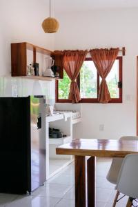 a kitchen with a table and a window at Casa Mura in Puerto Escondido