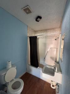 a bathroom with a toilet and a sink at CMI Hotel 1935 Myrtle Beach SC in Myrtle Beach +98 photos