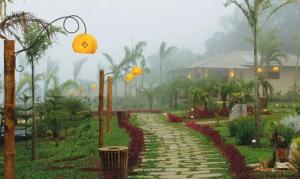 a walkway in a garden with lights and trees at Flat Guaramiranga - Apto 204 in Guaramiranga +7 photos