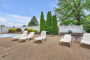 a group of white chairs sitting on a patio at Indiana Beach Hotel in Monticello