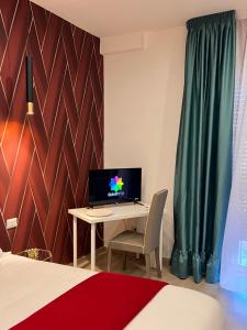 a bedroom with a desk with a computer on it at Stay & Fly in Naples +53 photos