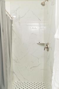 a white bathroom with a shower with a glass door at Duchesne River LLC in Duchesne +63 photos