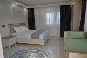 a bedroom with a bed and a window and a rug at Vıllaozden in Belek +58 photos